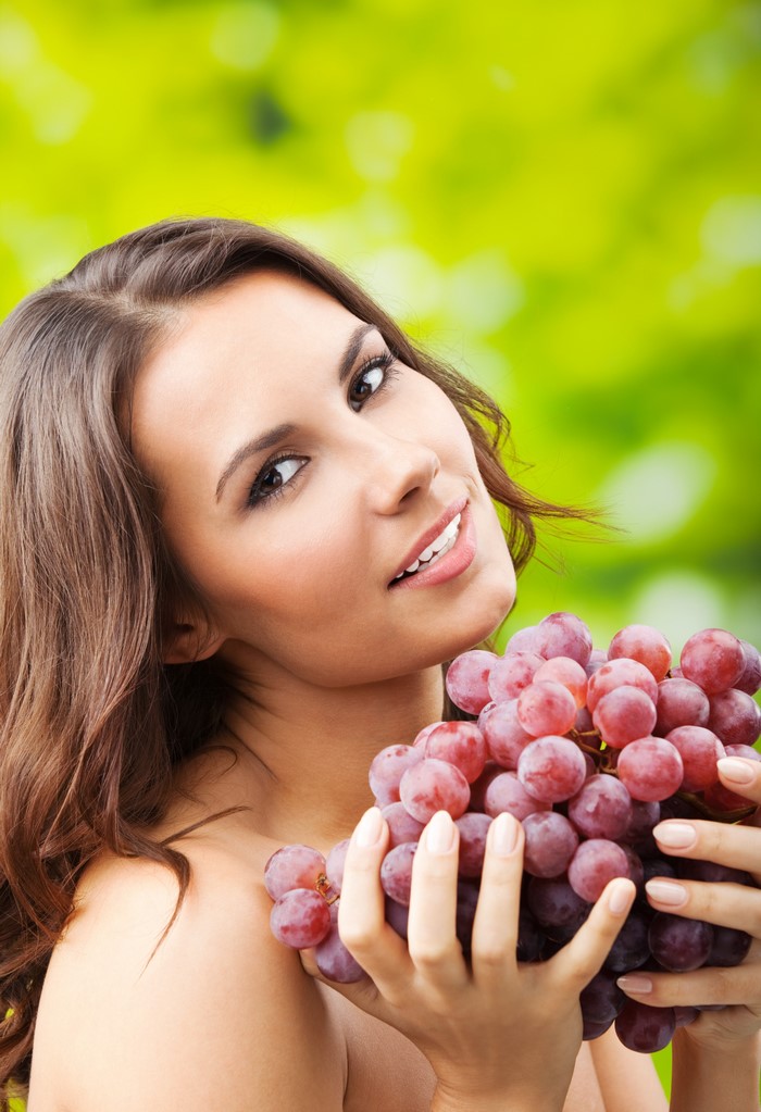 Woman holding red grapes