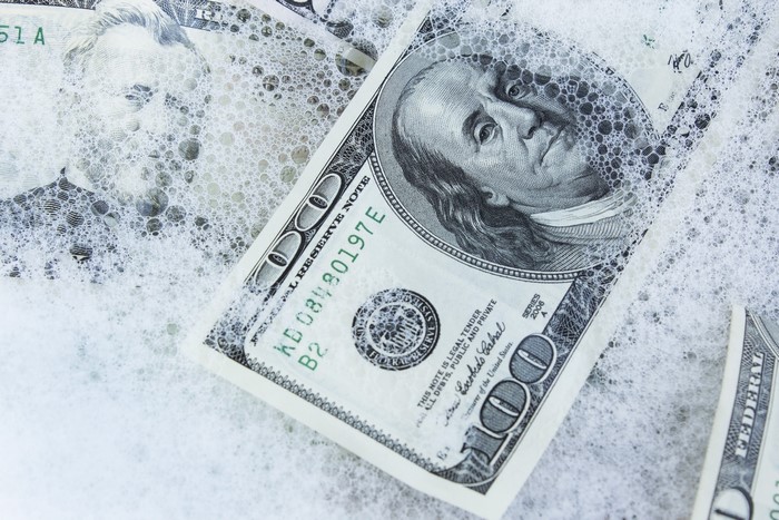100 Dollar Bills in Soap Suds
