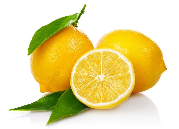 Lemons with leaves on white background