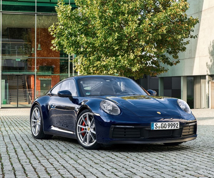 Blue Porsche 911 Carrera S parked outside building