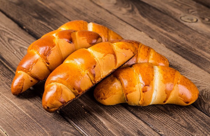 Golden Croissants on Wooden Planks