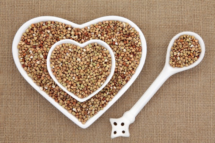 Buckwheat in heart-shaped bowls and spoon