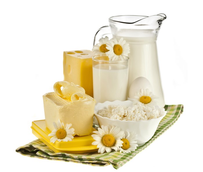 Dairy products with camomiles on white background