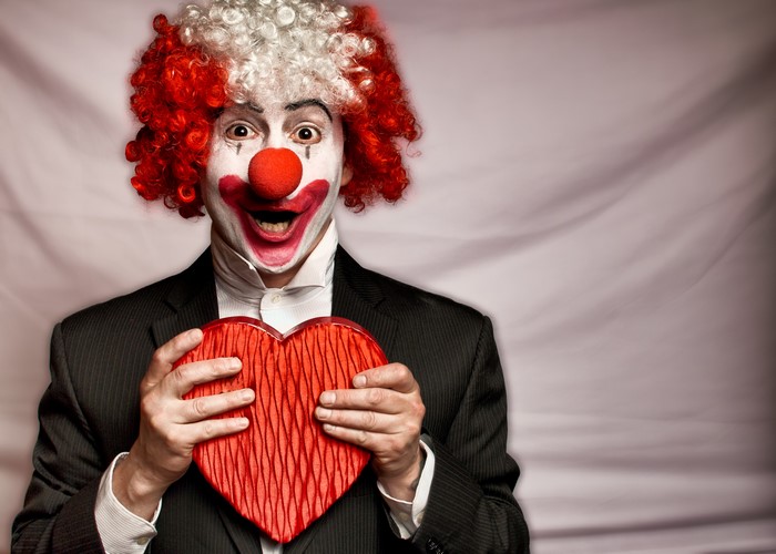 Clown in Suit Holding a Heart Box