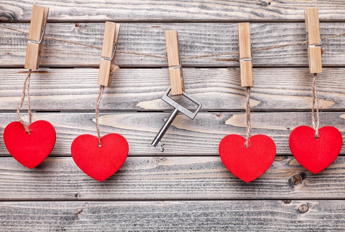 Valentine's Day hearts and key on wood planks