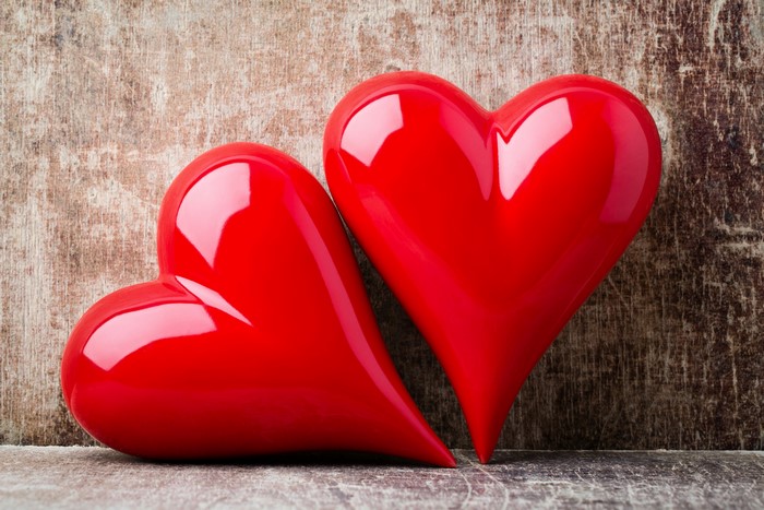 Two red hearts on a wooden background