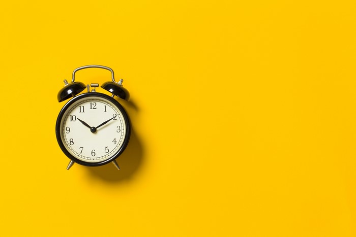 Alarm clock on a yellow background