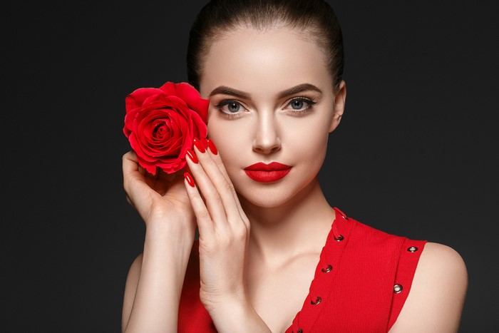 Woman with red rose and red dress
