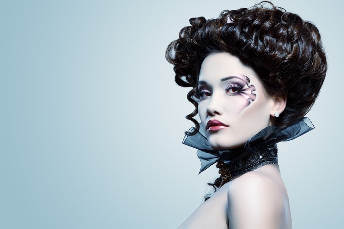 Brunette girl with dramatic makeup and hairstyle
