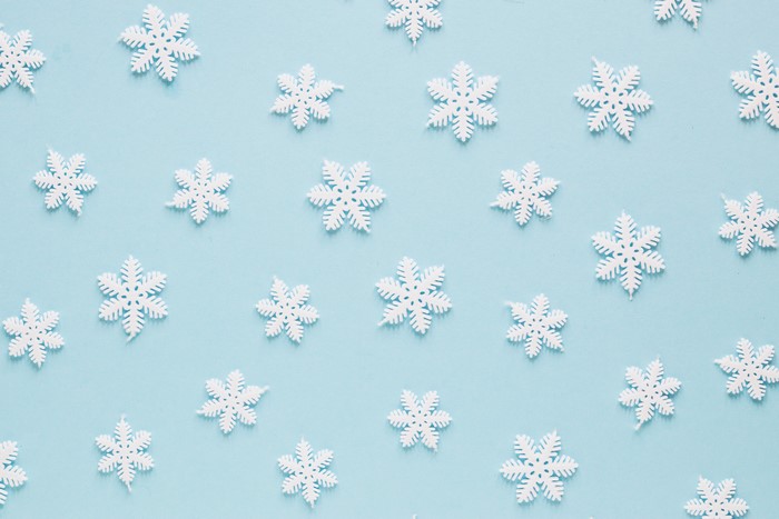 White snowflakes on a light blue background