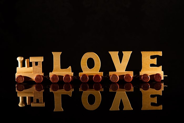 Wooden train with LOVE letters on black background
