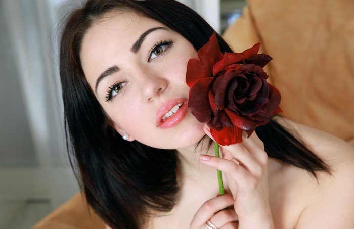 Brunette girl with a red rose