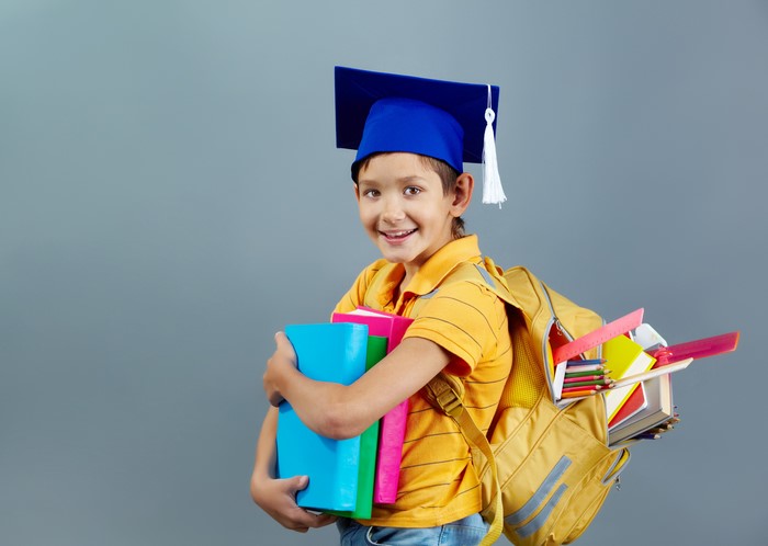 Boy with Graduation Cap and Books