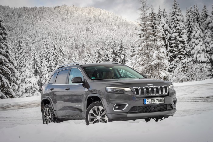 Grey Jeep Cherokee in Snowy Forest