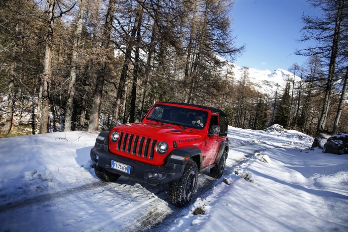 Red Jeep Wrangler Rubicon in Snowy Forest