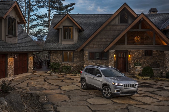 2019 Jeep Cherokee Limited parked in front of a stone house