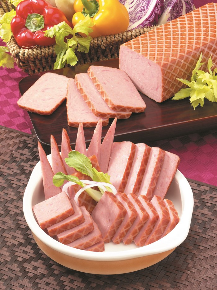 Sliced ham and vegetables on a platter