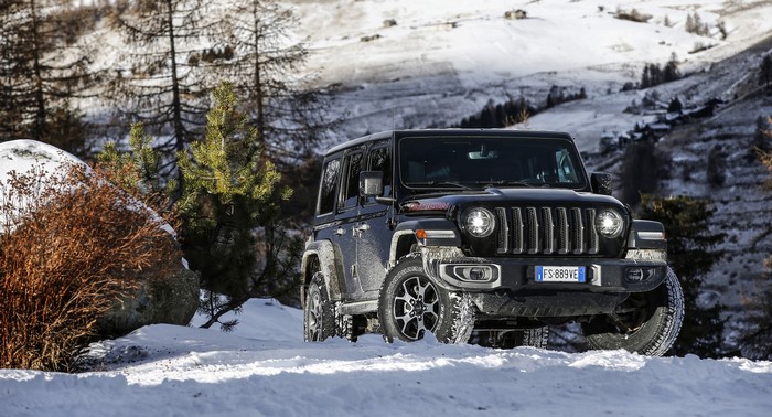 Black Jeep Wrangler Rubicon in Snowy Mountains