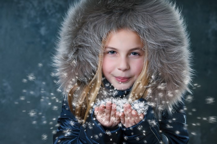 Girl in Winter Coat Holding Snow