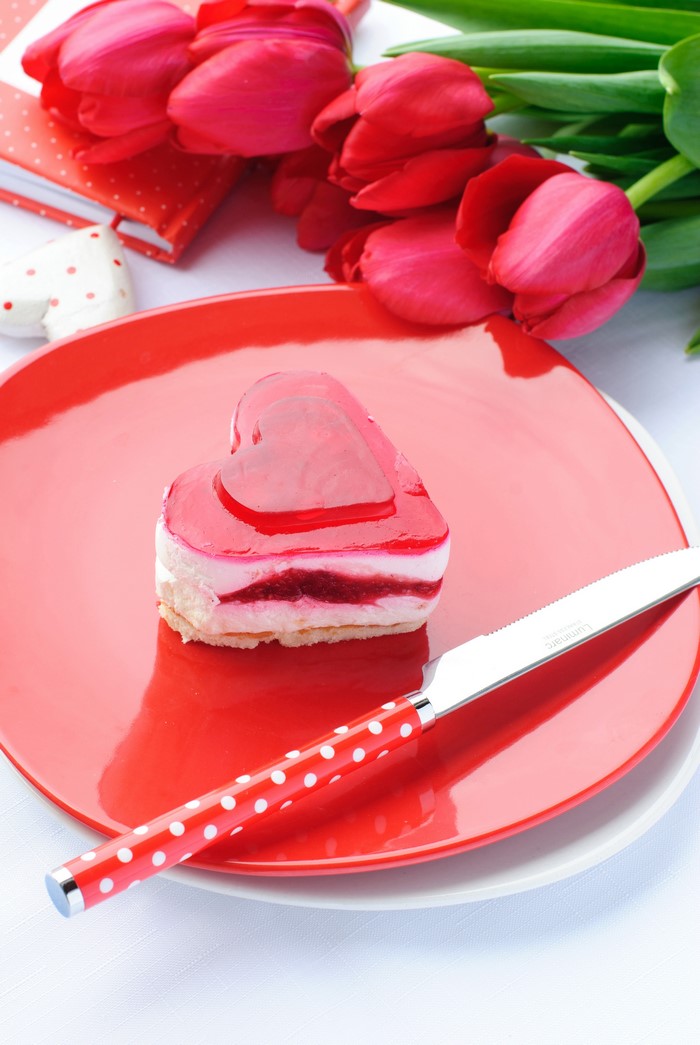 Heart-shaped cake with tulips and knife
