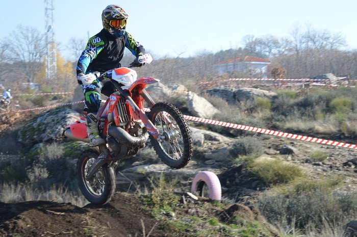 Motocross rider jumping over dirt terrain