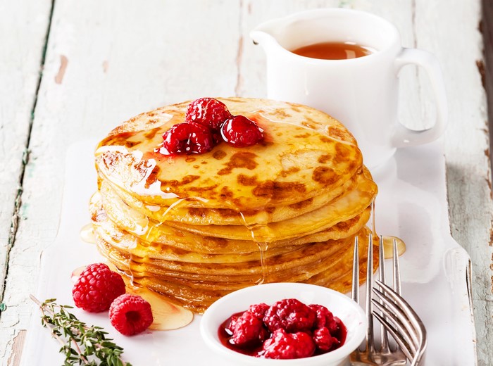 Stack of Pancakes with Raspberries and Syrup