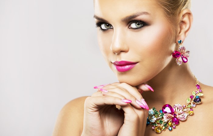 Woman with pink lipstick and colorful jewelry