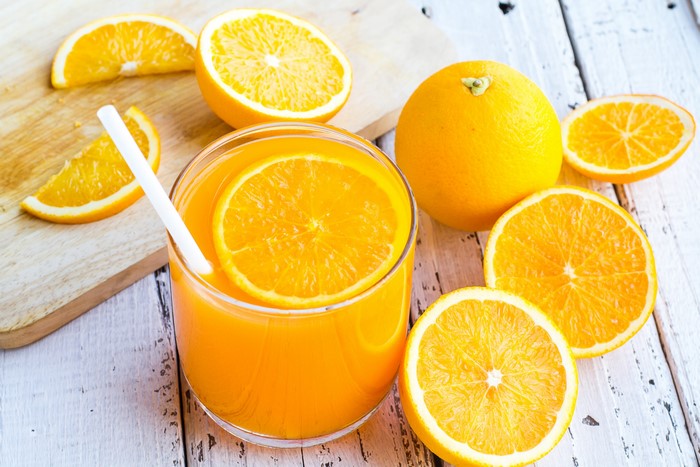 Orange juice in a glass with oranges