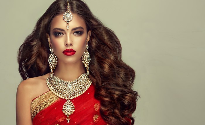 Elegant Woman in Red Saree with Jewelry 4K