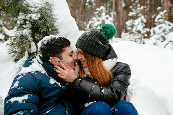Couple in love in a snowy forest