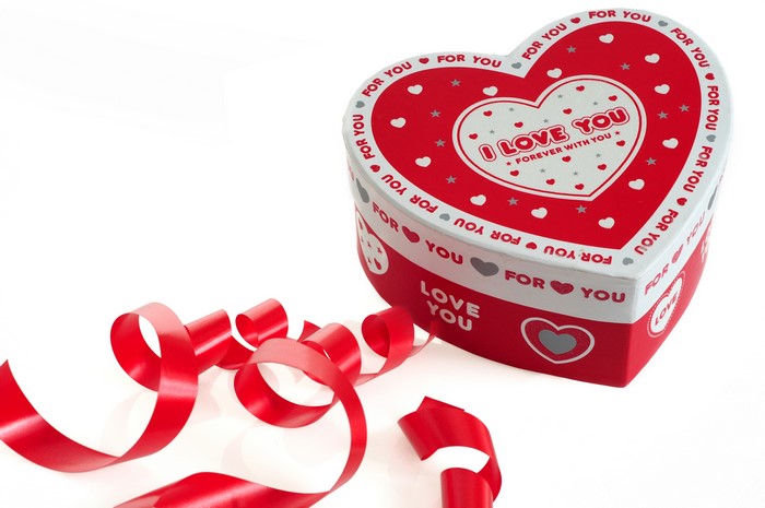 Heart-shaped gift box with red ribbon