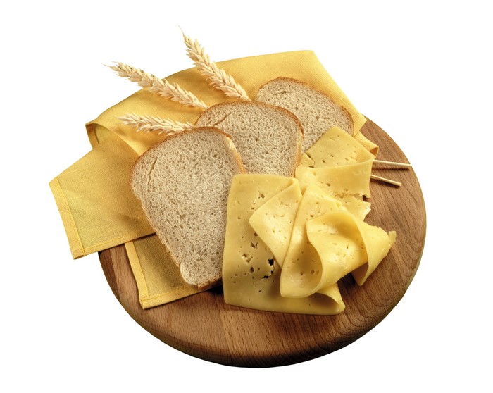 Bread, Cheese, and Wheat on a Wooden Board