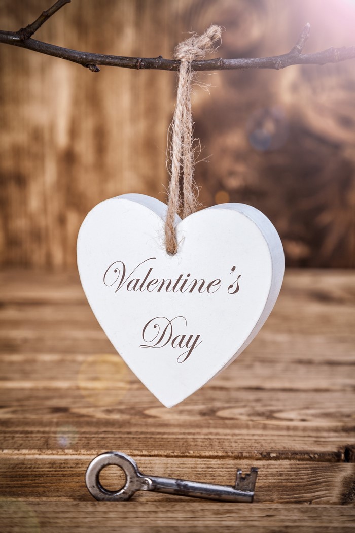 Valentine's Day heart decoration and key on wood