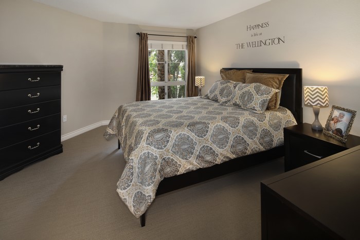 Bedroom with dresser, bed, and nightstand
