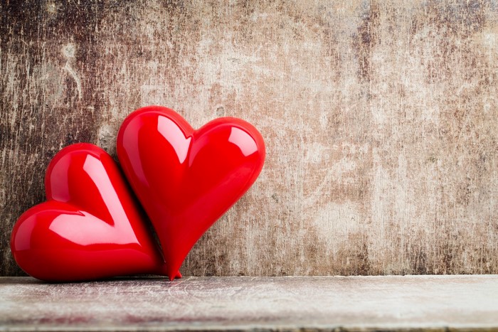 Two red hearts on a wooden background