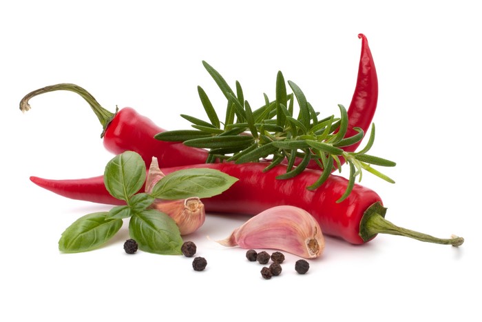 Red chili peppers, garlic, basil, rosemary, and black peppercorns