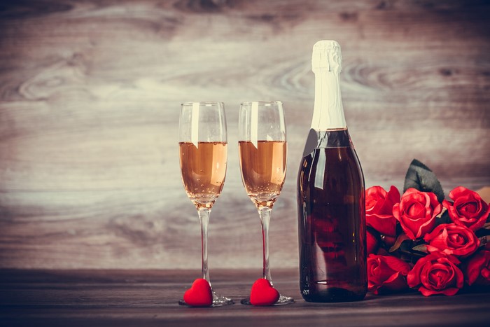 Champagne bottle, two glasses, and roses for Valentine's Day