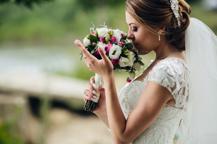 Bride smelling a bouquet