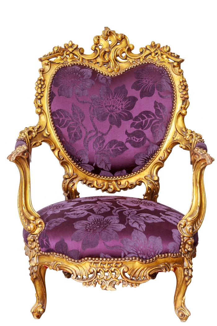 Ornate golden armchair with purple floral upholstery