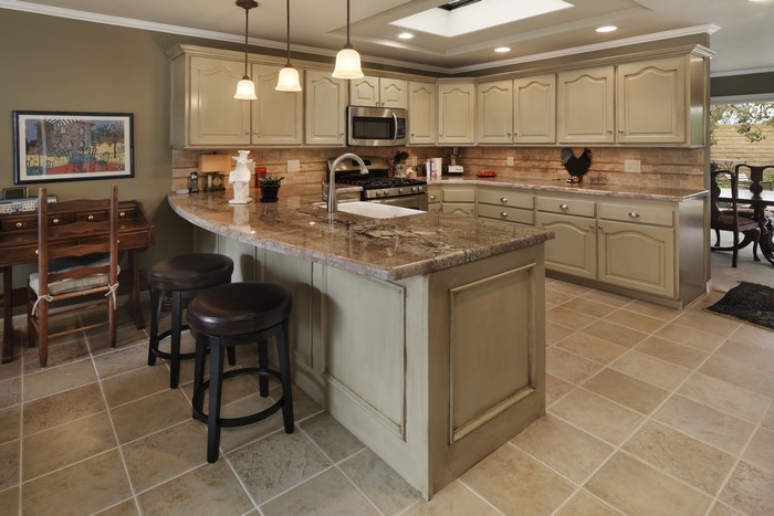 Kitchen with island, cabinets, and desk