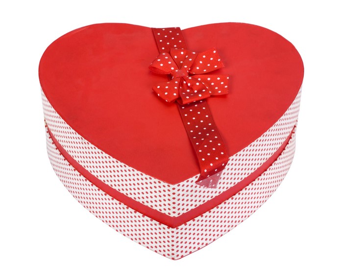 Red heart-shaped gift box with polka dot ribbon