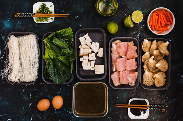 Ingredients for Asian Soup: Noodles, Tofu, Meat, Mushrooms, Vegetables, Eggs, Lime, Carrots, Oil, Sesame Seeds