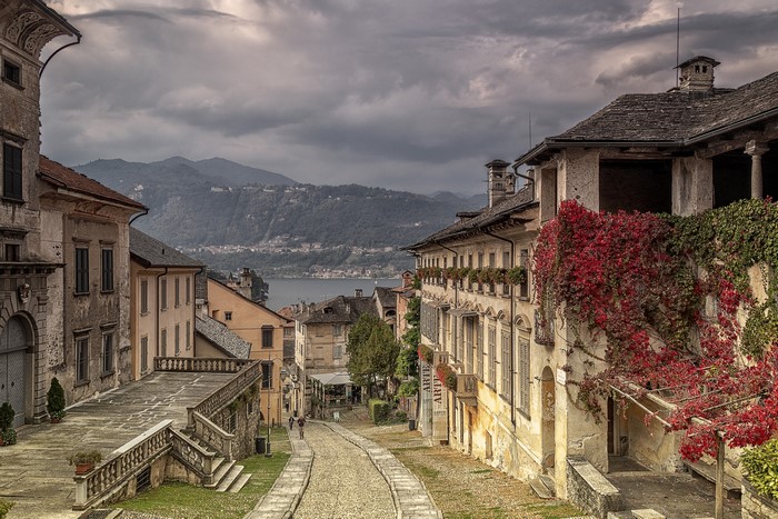 Street in Orta San Giulio, Italy with lake and mountains