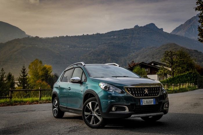 Green Peugeot 2008 Crossway SUV parked on a mountain road