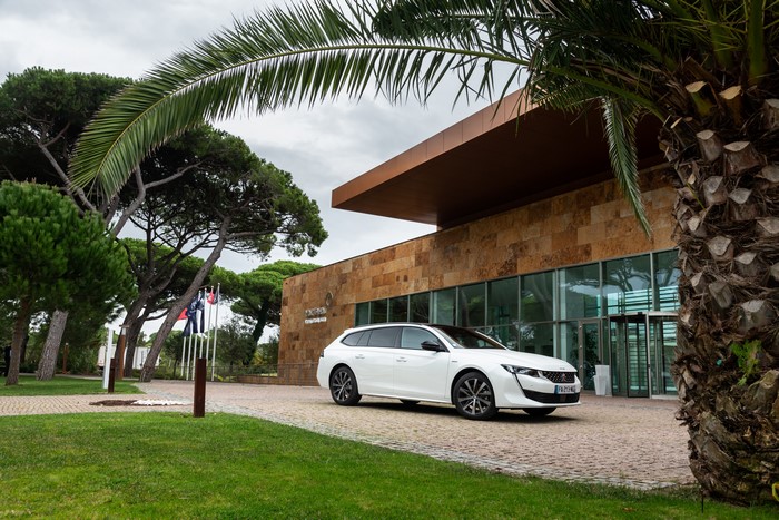 White Peugeot 508 SW GT Line parked outside building