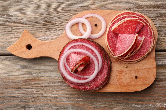 Sliced Salami and Onion Rings on Cutting Board