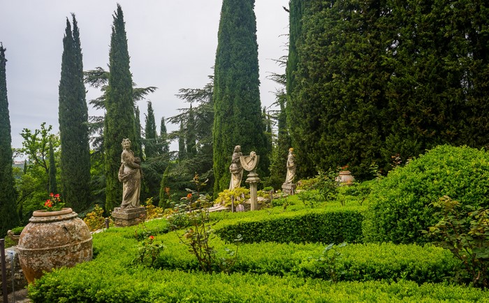 Villa Peyron Garden with sculptures and cypress trees in Italy
