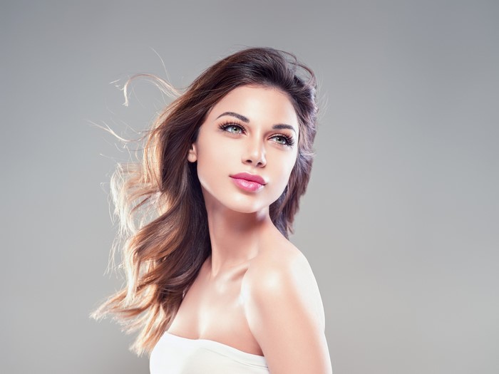 Brown haired woman with makeup and flowing hair