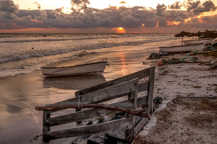 Boats on the beach at sunset in Hawmat as Suq, Tunisia