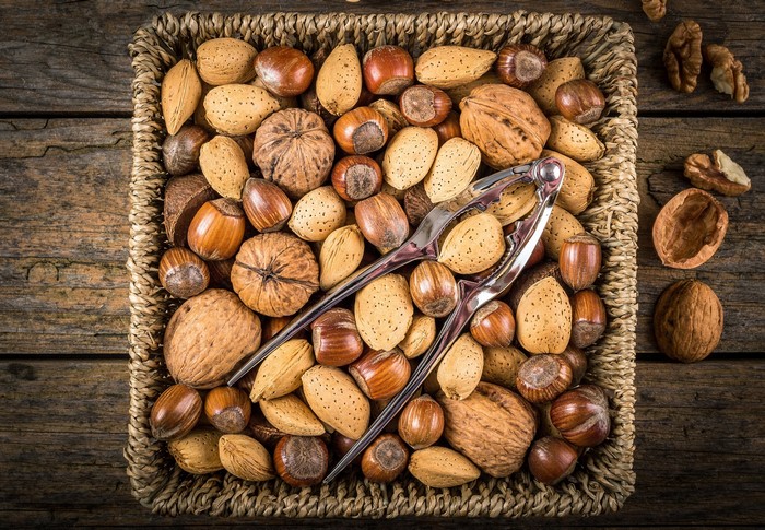 Basket of assorted nuts with a nutcracker